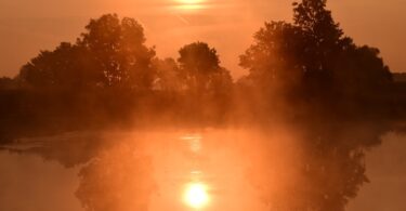 Violence and Faith- Sunrise over a pond