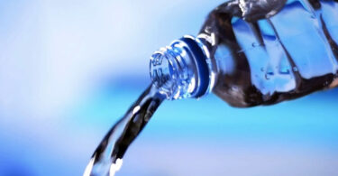 Water pouring from a bottle, summer hydration