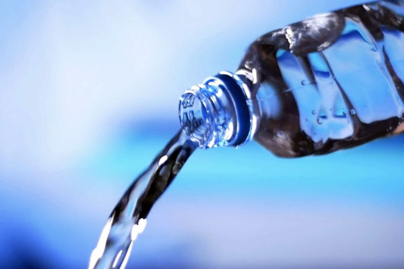 Water pouring from a bottle, summer hydration